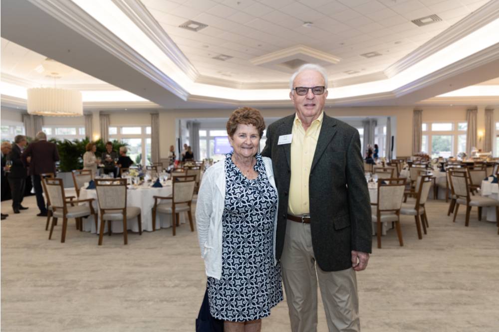 Ron Clark standing with other guest and posing for camera